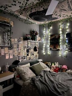 a bed room with a neatly made bed and lots of lights on the wall above it