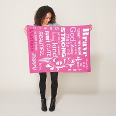 a woman holding up a pink sign with the names of her favorite places in it