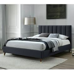 a bed that is in a room with white walls