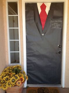 a front door decorated with sunflowers and a man's suit on it