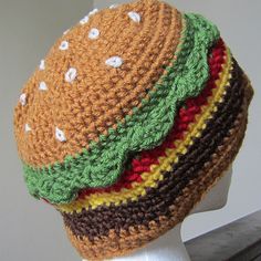 a crocheted hamburger hat on top of a mannequin's head