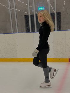 a woman is skating on an ice rink