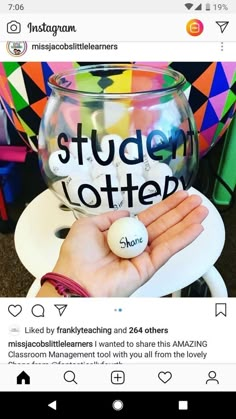 someone is holding a glass with the word student written on it