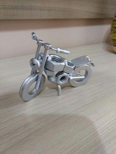 a small metal motorcycle is sitting on a table