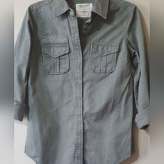 Women's Army-Green Long Sleeve Button Up Shirt. I Loved It But Fit Very Big So Never Used It, Has Some Accent On It As Well As Actually Chest Pockets Cotton Tops With Pockets And 3/4 Sleeves, Cotton Tops With 3/4 Sleeves And Pockets, Gray Shirt With Button Closure, Casual Shirt With 3/4 Sleeves And Buttons, Casual Tops With 3/4 Sleeves And Button Closure, Cotton Shirt With Button Closure And 3/4 Sleeves, Cotton Shirt With 3/4 Sleeves And Button Closure, Cotton Shirt With 3/4 Roll-up Sleeves, Cotton Shirt With Roll-up 3/4 Sleeves