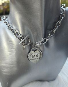 Unique handmade custom sorority necklaces available in silver for the stylish Delta that stands out in a crowd.  BE SURE TO PROVIDE ACCURATE MEASUREMENTS TO AVOID 10.00 RESIZE FEE.  (CONSIDERING WHERE YOU WOULD LIKE THE NECKLACE TO FALL). Products will not tarnish, as they are made using stains steel. Silver Toggle Necklace With Charms For Gifts, Personalized Silver Toggle Necklace Gift, Silver Personalized Sorority Jewelry, Personalized Silver Sorority Jewelry, Personalized Sorority Jewelry Gift, Engraved Silver Toggle Necklace As Gift, Sorority Necklace, Delta Sigma Theta Gifts, Fall Products