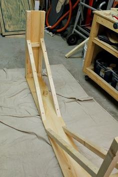 some wood is laying on the ground and ready to be used as a frame for a chair