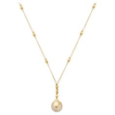 The South Sea Pearl Pendant Necklace is a resplendent piece from Yvel's Golden Brown Collection, showcasing a magnificent 14 by 16 mm. golden South Sea pearl. This necklace, crafted in 18K yellow gold, allows the pearl to take center stage, its satiny sheen reflecting the warm light and opulence of the seas from which it came. This necklace exemplifies Yvel's dedication to nature's splendor, offering an iconic piece that complements the collection's exotic elegance. * Features a large 14 x 16 mm Pearl Lariat Necklace, Tahitian Pearl Necklace, Cognac Diamonds, Large Pendant Necklace, Golden South Sea Pearls, Nugget Necklace, Sea Pearl, Modern Necklaces, South Sea Pearls