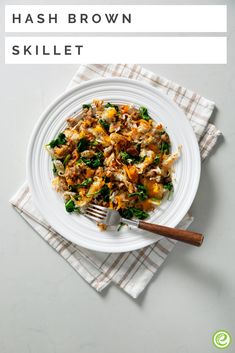 hash browns skillet on a white plate with a fork and napkin next to it