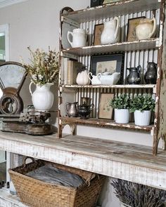 an old shelf with baskets and vases on it