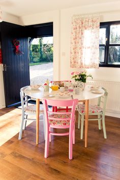 a dining room table with four chairs around it