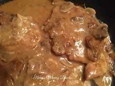 meat and mushrooms covered in gravy in a skillet