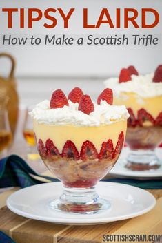 two dessert dishes with strawberries and whipped cream on top, sitting on a wooden table