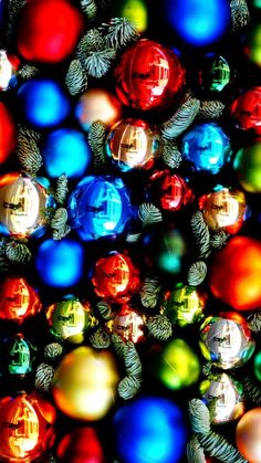 many different colored christmas ornaments are arranged in the shape of an ornament,