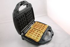 two waffles sitting on top of each other in a black pancake maker