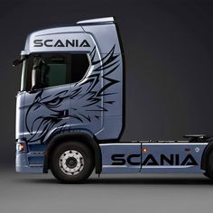 the scania truck has an eagle painted on it's front end and side