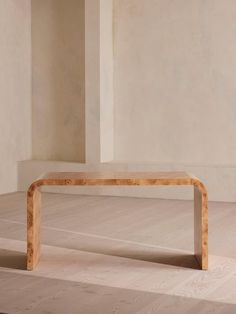 a wooden bench sitting on top of a hard wood floor