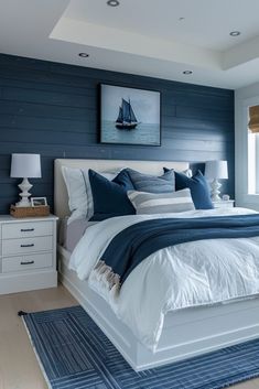 a bedroom with blue walls and white furniture