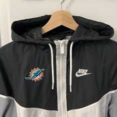 Really Soft, Lightweight, Stylish Jacket. For Sure Comes In Handy At A Rainy Game. Worn Only A Few Times. Excellent Condition. There’s A Thread Mark Noted, But It’s In The Stitching. I Am A Small And This Fits Well. So It Will Fit A Small Or A Medium Depending On How Fitted You Like It. Windy Conditions Are No Match For This Windrunner Hooded Jacket From Nike. This Super Lightweight Windbreaker Is Made From Moisture-Wicking Polyester To Keep You Dry In Inclement Weather. Nike Branding At Chest C White Nike Track Jacket For Outdoor Activities, Nike White Hooded Windbreaker, Nike White Track Jacket For Outdoor Activities, White Hooded Nike Windbreaker, White Nike Hoodie For Sports Events, Nike White Hoodie For Sports Events, Nike Urban Style White Windbreaker, Urban Hooded Windbreaker For Sports Events, Nike White Functional Hooded Jacket