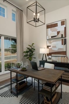 a living room with a table, chair and lamp in it's centerpiece