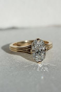 a diamond ring sitting on top of a table