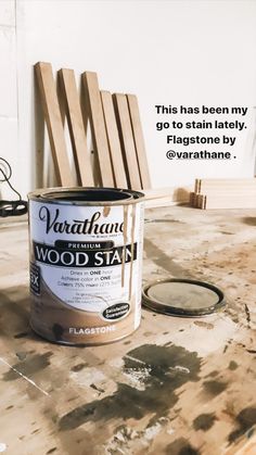 a can of wood stain sitting on top of a table