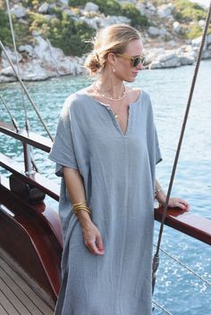 Style // The ultimate stormy blue kaftan is perfect for any occasion When comfort meets style, the Cala Kaftan features a billowy, shapeless silhouette and mid-length. With a v-neck silhouette, wide sleeves and two side slits, it promises to be your go-to look for that cozy, effortless look. The lightweight linen-cotton blend fabric is extra soft, to ensure you won't ever want to take it off Fabric Note // Made in Italy from a Linen & Cotton blend Sizing Advice // Available in one size, for an o Oversized V-neck Tunic For Beach Cover-up, Casual V-neck Kaftan For Daywear, Blue Relaxed Fit V-neck Tunic, Casual V-neck Relaxed Fit Kaftan, Blue V-neck Kaftan For Loungewear, Oversized Summer Tunic With V-neck, Summer Oversized V-neck Tunic, Oversized V-neck Summer Tunic, V-neck Tunic For Daywear With Relaxed Fit