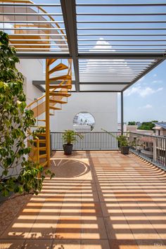 the sun shines on an outdoor patio with stairs and potted plants in it