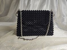 Handmade Black Beaded Bag with Silver-Toned Hardware This elegant handbag, crafted from black beads, features silver-toned hardware and a 47-inch removable chain. The magnetic closure adds convenience and ease of use. Our bags are 100% handmade. Each bag is unique and crafted with love for our customers. It takes 3-5 days to create one bag. A perfect gift for women, friend, family member or loved one. Ideal for any celebration, event, wedding or birthday party. This unique and distinctive bag wi Black Beaded Rectangular Clutch, Formal Rectangular Bag With Black Beads, Elegant Rectangular Shoulder Bag With Black Beads, Black Rectangular Evening Bag With Black Beads, Black Beaded Rectangular Evening Bag, Evening Shoulder Bag With Black Beads Rectangular Shape, Black Beaded Rectangular Shoulder Bag, Evening Rectangular Shoulder Bag With Black Beads, Handmade Black Evening Bag For Events