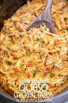 slow cooker quesadilla chicken tacos in a crock pot with a wooden spoon