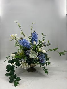 a vase filled with blue and white flowers