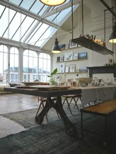 a dining room table in front of large windows