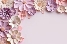 an overhead view of paper flowers on a pink background