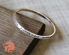 "This custom bangle bracelet is made of sterling silver (92.5%) and hand stamped with the names of your loved ones or the message of your choice. Price is per bangle, so order the quantity you need. What a great gift for a mother or grandmother in your life. Each bangle can be stamped with up to aprox. 75 characters (including spaces). Text is only stamped on one side. Each bracelet is made by hand, formed, hammered and polished to a high shine. These bangles are handcrafted in the size and quan Grandma Bracelet, Custom Bangle, Message Bracelet, Moms Bracelet, Sterling Silver Bangle, Rose Gold Heart, Brave Soul, Cross Bracelet, Name Bracelet