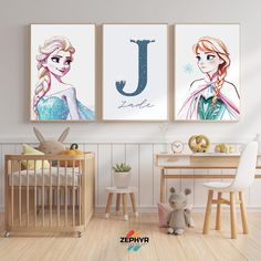 two frozen princess posters hanging in a child's room next to a crib