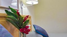 a hotel room with two beds and flowers in the vase