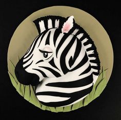 a zebra shaped cake sitting on top of a plate