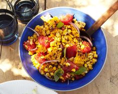 two plates of food on a table with wine glasses and utensils next to them