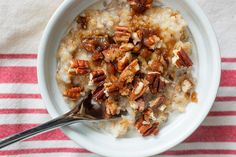 a bowl filled with oatmeal topped with pecans