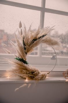 a window sill with some dry grass in front of it