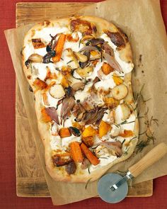 a pizza sitting on top of a wooden cutting board