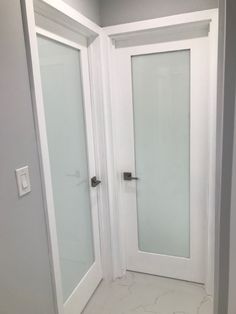 an empty room with two white doors