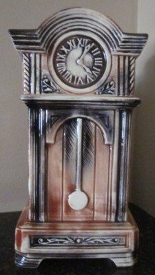 an antique clock is sitting on a table