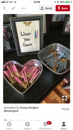 two tins with clothes pins in them and a sign that says wear your guess