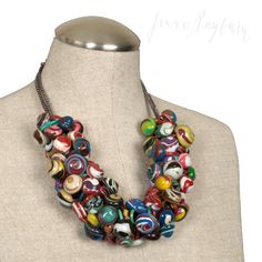 a necklace made out of glass beads on a mannequin