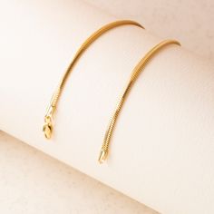 Our 14K Gold Snake Chain Bracelet is the epitome of sleek design and modern luxury. This handcrafted piece, with its distinctive flat snake chain, offers a smooth and comfortable fit, making it perfect for daily wear or special occasions. The high-quality 14K gold construction not only imparts lasting durability but also an undeniably elegant aesthetic. Available in various widths and lengths, this bracelet can be personalized to your exact preference for a snug or more relaxed fit. Key Features Flat Snake Chain, Gold Snake Chain, Snake Chain Bracelets, Elegant Aesthetic, Gold Flats, Gold Snake, Classic Gold, Exquisite Jewelry, Snake Chain