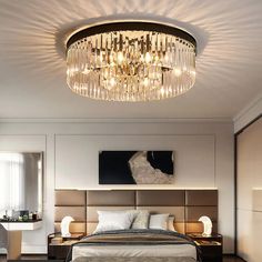 a bedroom with a large bed and chandelier