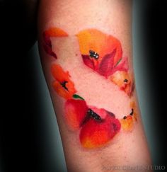 a tattoo with flowers painted on it