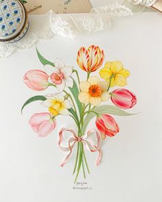 a drawing of flowers on a white paper with laces and scissors next to it