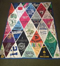 a quilt with many different colors and designs on the front, along with words that spell out